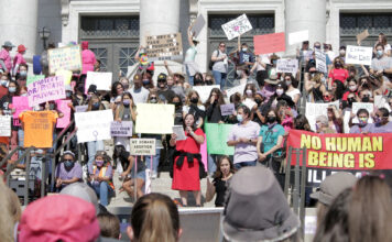 Women’s March rally protests restrictive abortion laws Democratic Rep. Angela Romero surrounded by protesters on capitol steps
