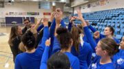 Undefeated conference record on the line for Bruins volleyball; women’s basketball preview Volleyball players huddle together with raised hands
