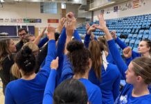 Undefeated conference record on the line for Bruins volleyball; women’s basketball preview Volleyball players huddle together with raised hands