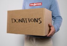 SLCC supports Afghan refugees by donating supplies Volunteer carrying box of donations