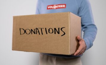 SLCC supports Afghan refugees by donating supplies Volunteer carrying box of donations