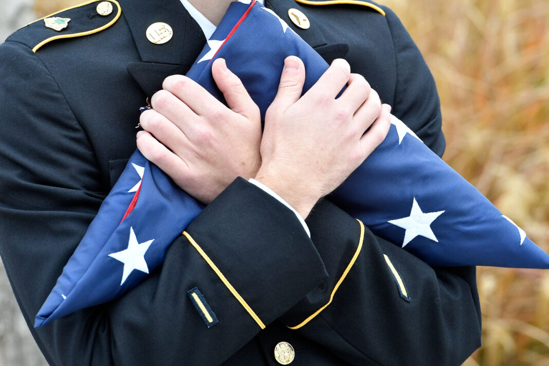 Cadet holds folded American flag