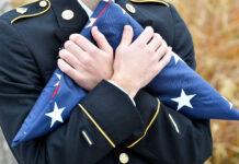 Photos: SLCC commemorates Veterans Day with flag ceremony Cadet holds folded American flag