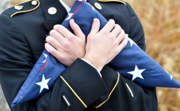 Photos: SLCC commemorates Veterans Day with flag ceremony Cadet holds folded American flag