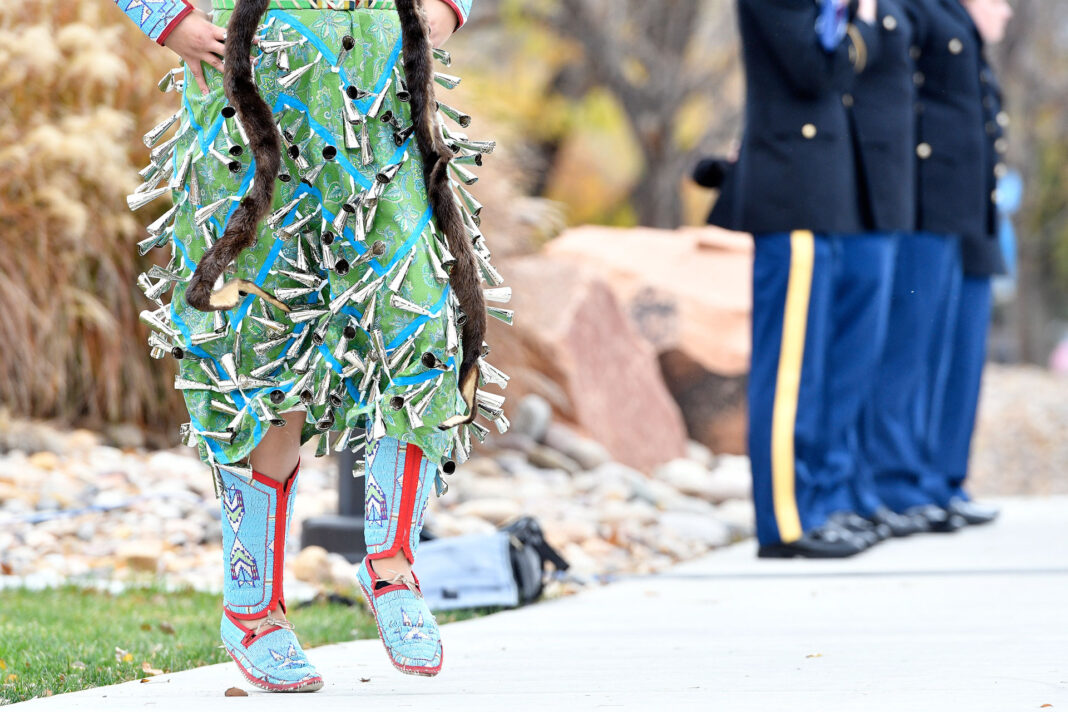 Rocklyn Merrick performs a native dance near ROTC cadets