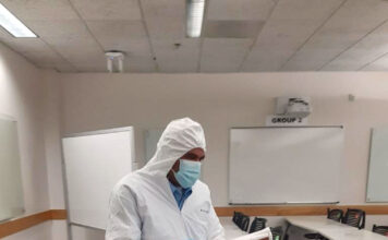 SLCC experiencing custodial staff shortage; down 42% Josh Auava'a cleans a room while wearing special protective clothing