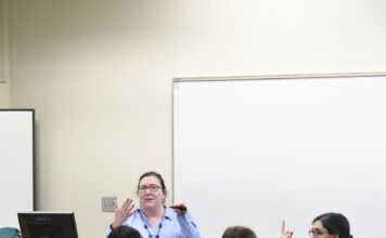 SLCC offers support for students with disabilities Francescia Paxton, seated right, interprets a teacher's lesson