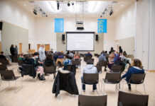 Student documentaries debut at South City Campus Socially-distanced audience awaits a film screening