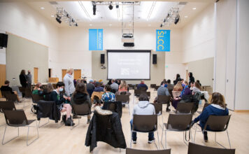 Student documentaries debut at South City Campus Socially-distanced audience awaits a film screening