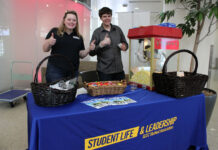 Back to school: SLCC Student Association Two people give thumbs up at the Student Life & Leadership table