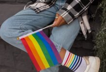 Why some LGBTQ students in Utah say their health education is inadequate Close-up photo of Pride Flag held by a person