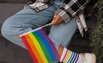 Why some LGBTQ students in Utah say their health education is inadequate Close-up photo of Pride Flag held by a person