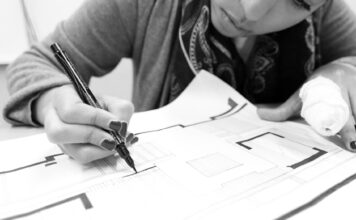 Students discuss challenges of learning while working Black-and-white photo of an architecture student