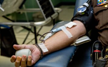 LGBTQ community questions blood, plasma donor qualifications Person on chair donating blood
