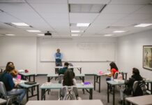 Online vs. in-person classes: Choice returns following pandemic Teacher proctoring his students during an examination