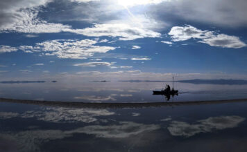 ‘Embrace the salt’ — A kayaker’s quest to share up-close views of an ‘epic’ but shriveling Great Salt Lake Man paddling a kayak across a lake