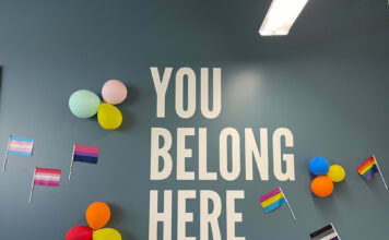 SLCC kicks off events for Pride Month Pride flags, balloons decorate an office wall with text that reads "you belong here"