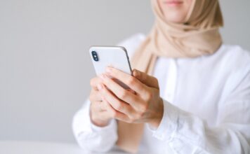 Students react to new messaging features in upcoming iPhone update Woman holds an iPhone X