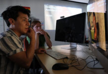 Local youths produce multimedia vaccination awareness campaign Two people edit a video project