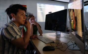 Local youths produce multimedia vaccination awareness campaign Two people edit a video project