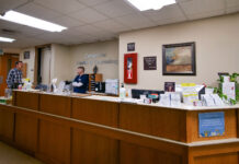 SLCC offers affordable mental and physical health services Two staff members have a conversation inside the Center for Health and Counseling