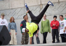 Photos: Bruin Bash launches fall 2022 semester Student is doing a one-arm handstand during a dance routine