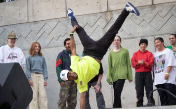 Photos: Bruin Bash launches fall 2022 semester Student is doing a one-arm handstand during a dance routine