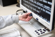 Disability Resource Center offers accommodation to students Person adjusts a dial on a screen magnifier