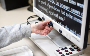 Disability Resource Center offers accommodation to students Person adjusts a dial on a screen magnifier