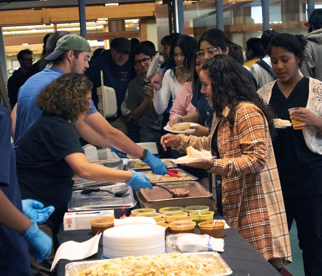 Servers dish Latin cuisine to attendees