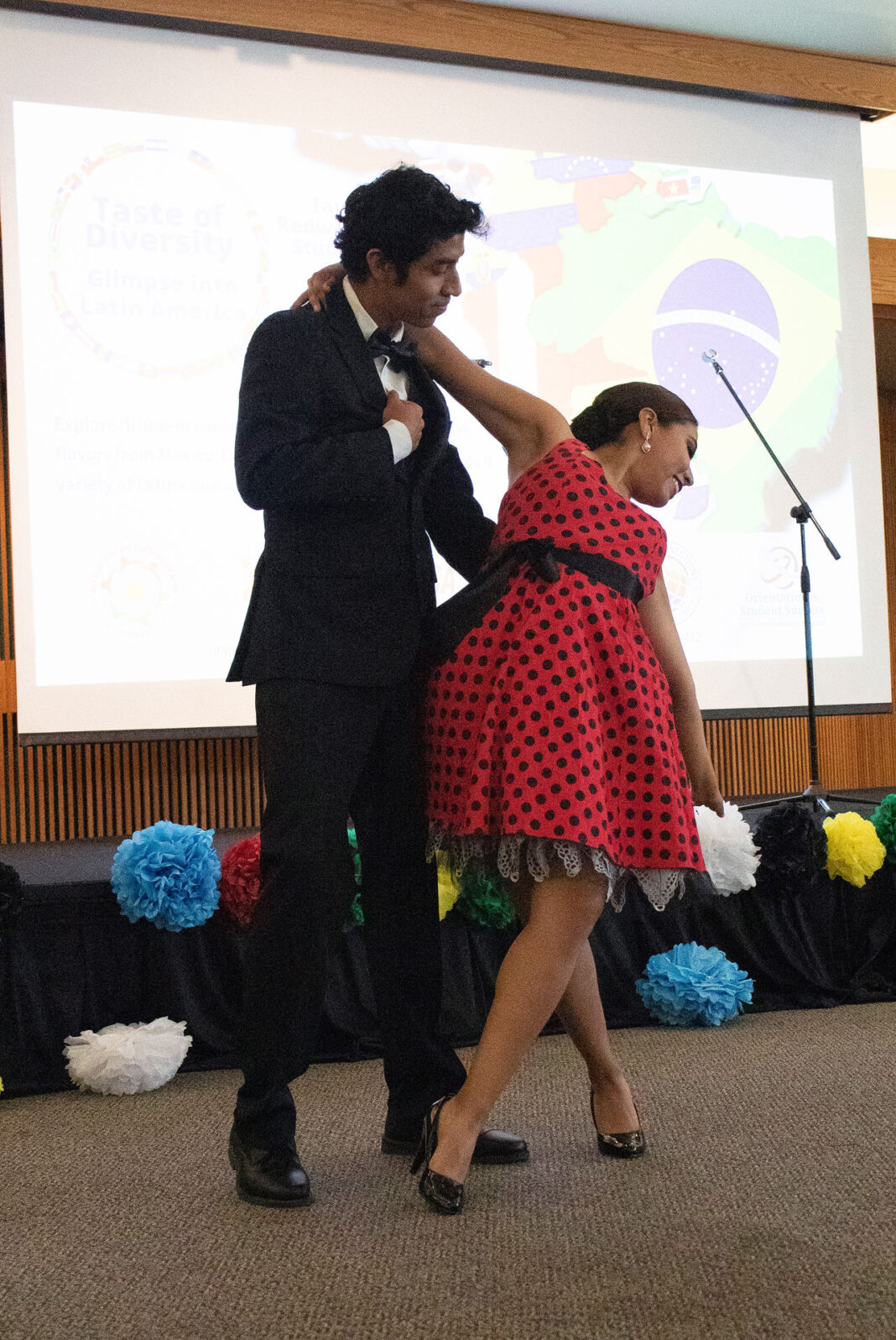A male and female dancer perform on stage