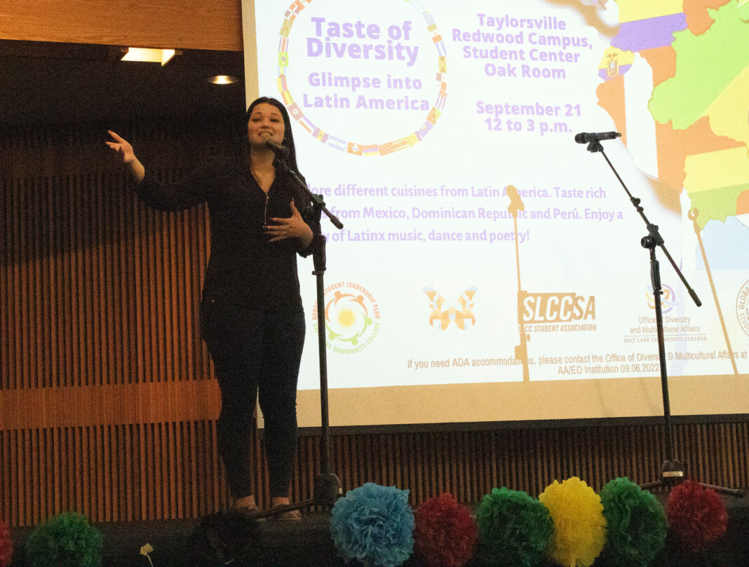 A woman stands at the microphone on stage