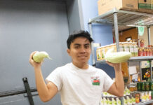 Bruin Pantry provides relief for college community amid rising inflation Alex holds two cucumbers inside the food pantry