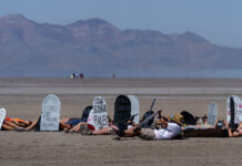 Utah youths hold ‘die-in’ for Great Salt Lake, challenge elected leaders to take bolder action Multiple people lie on the lakebed with makeshift tombstones