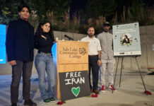 School multicultural groups hold a vigil to honor Mahsa Amini Four people stand by a Salt Lake Community College podium with a "Free Iran" sign and a poster for the Mahsa Amini candlelight vigil