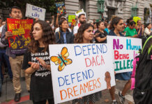 SLCC leaders express disappointment over recent DACA decision that leaves program in limbo Multiple people hold signs and applaud in support of DACA
