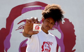 Murals paint memories of those lost to police violence across the US Rae Duckworth holds a "Justice for Bobby" sticker near a mural in Salt Lake City