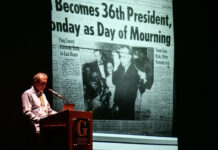 Former White House photographer tells stories of humanity in the nation’s highest office Pete Souza stands at a podium beside LBJ's swearing-in photo projected on a screen