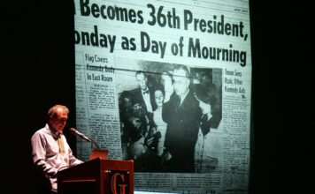 Former White House photographer tells stories of humanity in the nation’s highest office Pete Souza stands at a podium beside LBJ's swearing-in photo projected on a screen