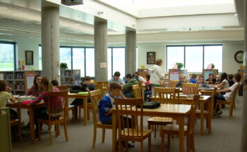 As educators leave at increasing rates, advocates and students express worry Students sit at tables in a library