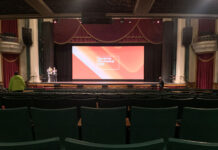 Sundance returns to Grand Theatre after COVID hiatus Rows of empty green theater seats in front of projection screen for Sundance