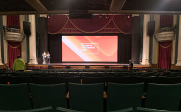 Sundance returns to Grand Theatre after COVID hiatus Rows of empty green theater seats in front of projection screen for Sundance