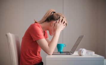 Struggling with classes? Teachers offer some tips Woman in red T-shirt looking at her laptop