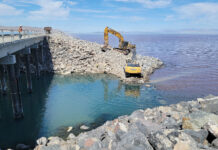 Cox orders division to raise Great Salt Lake causeway berm another 5 feet Two excavators move large rocks near Great Salt Lake causeway