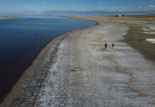 Utah legislature eyes changing approach to saving Great Salt Lake Two people walk along receded Great Salt Lake shoreline