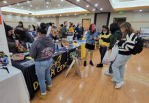 Photos: Spring 2023 Mega Fair People gathering around a table for the Dream Center