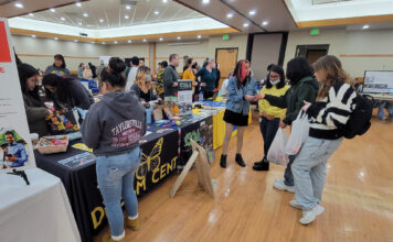 Photos: Spring 2023 Mega Fair People gathering around a table for the Dream Center