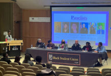 Black Student Union hosts panel on racism and hate speech Six people seated at a Black Student Union table for a panel discussion on racism and freedom of speech