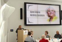 Section of Westpointe Center named after retired Sen. Karen Mayne Deneece Huftalin at podium during Karen Mayne naming ceremony