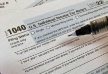 Filing taxes doesn’t have to be complicated, professors say A pen hovering over a Form 1040, U.S. Individual Income Tax Return